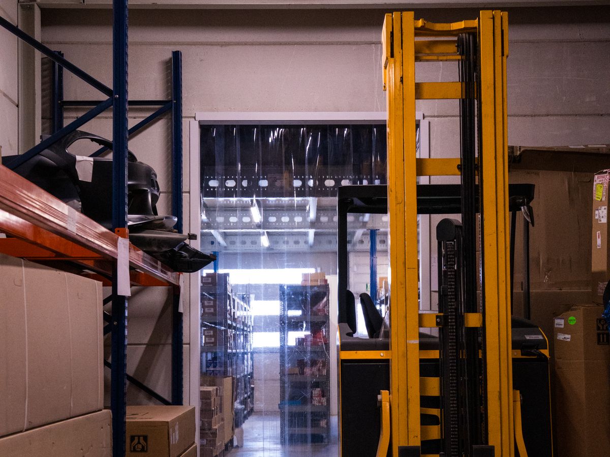 Reach truck in a warehouse aisle